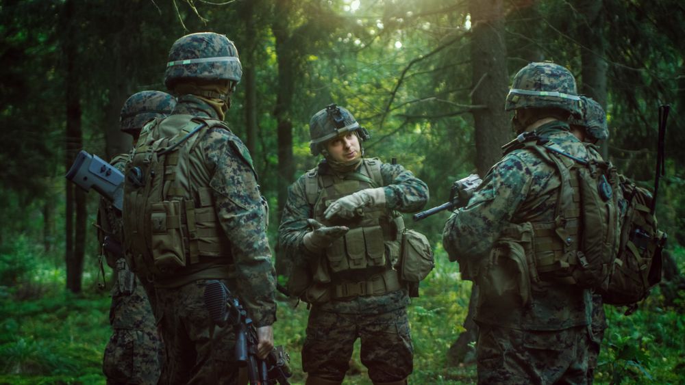Squad Leader Discusses Military Operation Details with Soldiers, Commander Gives Orders.