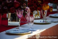 Close up of pink crystal wine glass at elegant formal dinner table 42Dxd0