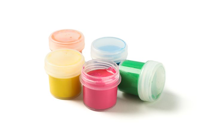 Color gouache paint cans isolated on studio background