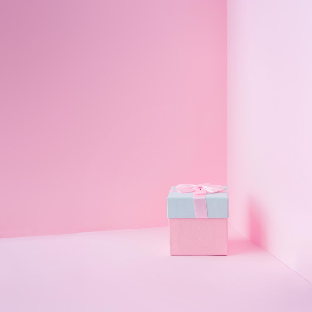 Pink and baby blue jewelry gift box on pastel backdrop