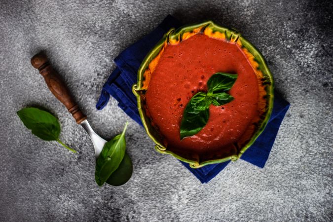 Top view of traditional tomato soup in a green bowl