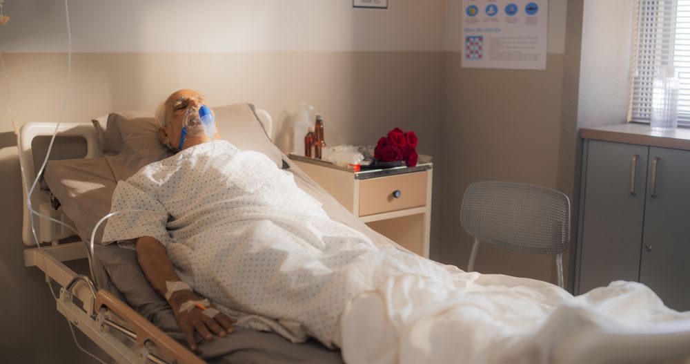 Hospital Ward: Portrait of Indian Mature Man Wearing Oxygen Mask Sleeping in Bed, Recovering after Sickness and Successful Surgery.