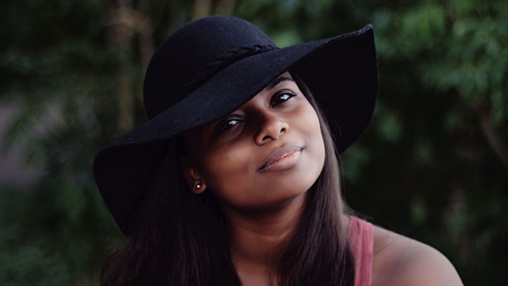 Head shot of woman wearing hat