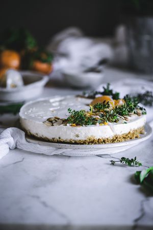 Tangerine cake decorated with whipped cream and sliced citrus