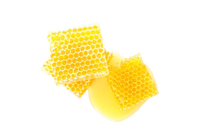 Pieces of honeycomb isolated on plain background, top view