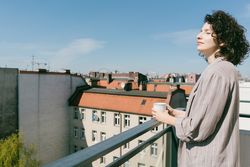 Elegant woman enjoying sun at terrace