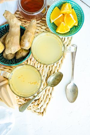 Ginger detox drink on placemat with ingredients