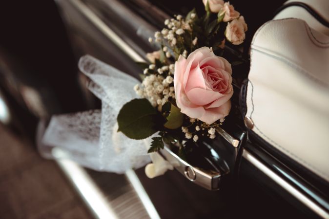 Pink flower on handle of retro car