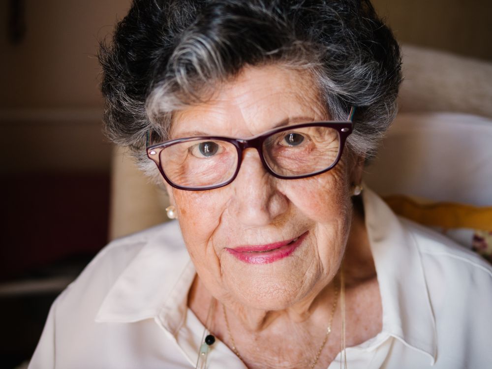 Happy mature woman in glasses at home