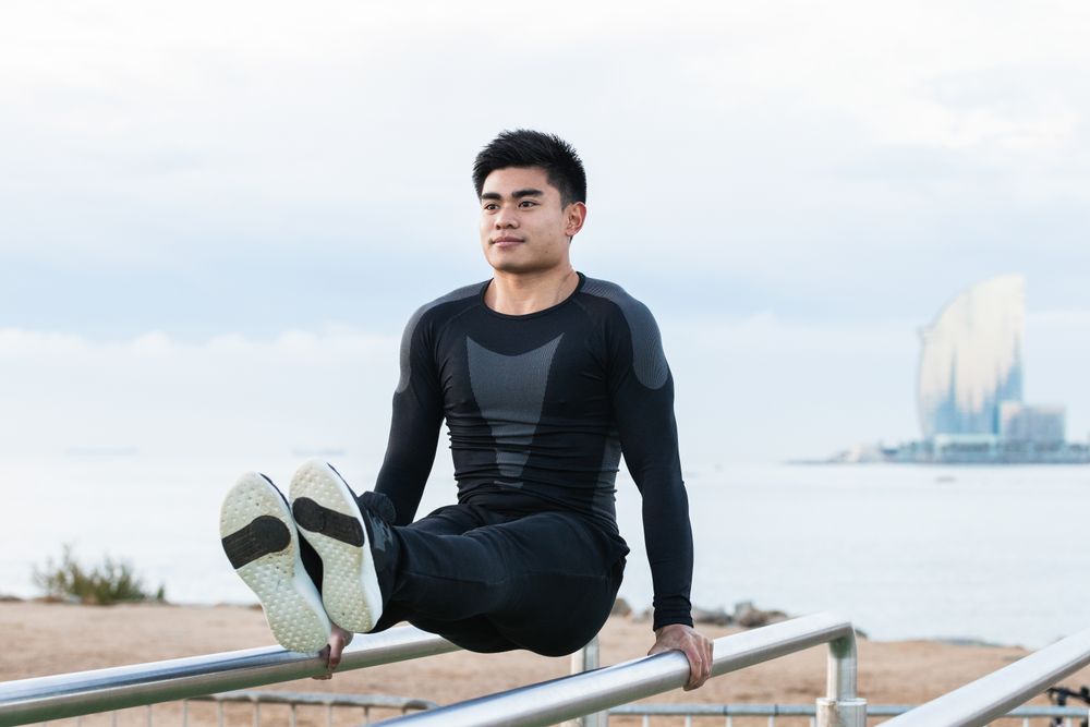 Sportsman exercising on parallel bars