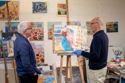 Two men talking in art studio