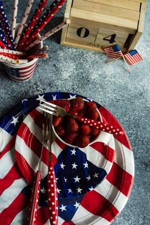 Independence Day celebration table setting on grey counter with strawberries