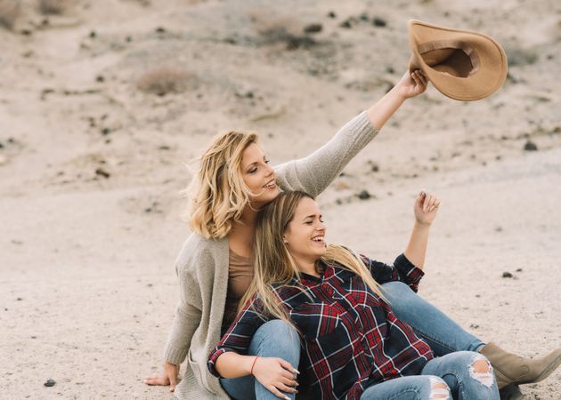 Content blond women cuddling on nature