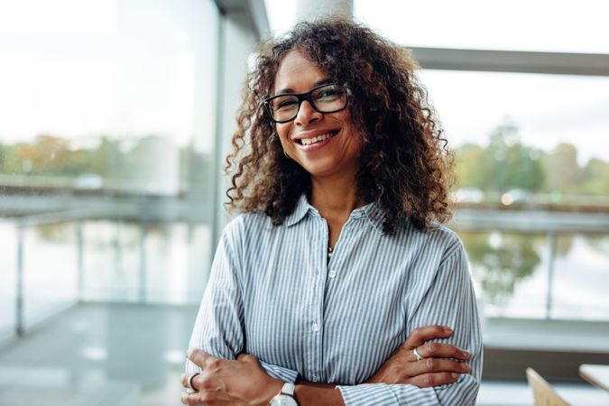 Portrait of female professional with curly hair wearing eyeglasses