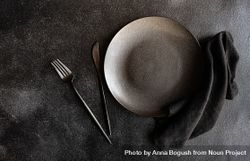 Dark plate, with similarly colored napkin and cutlery 432Qpj