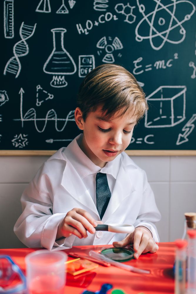 Happy kid using magnifying glass