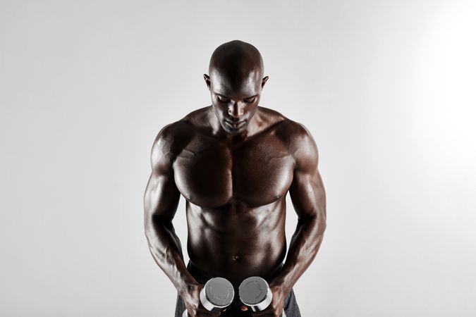 Male fitness exercising with hand weights