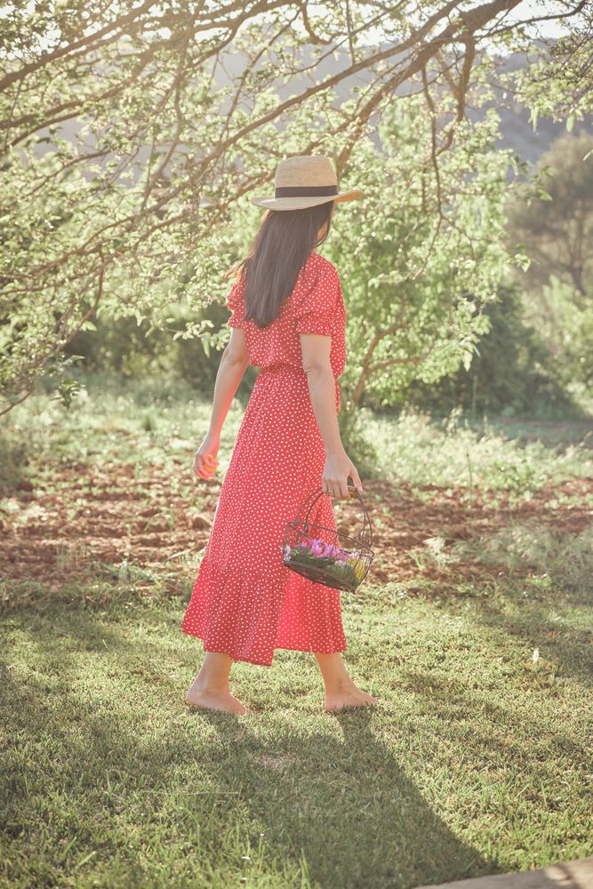 Woman walking in summer garden