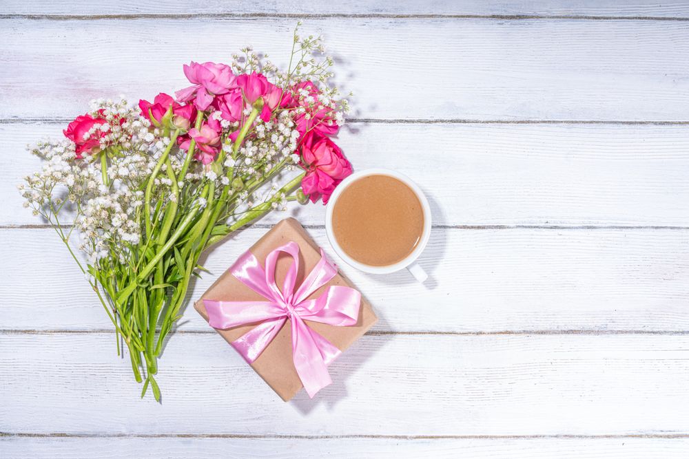 Background with flowers bouquet and gift