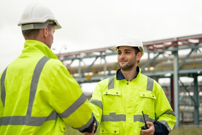 Engineer worker hand shaking to colleagues team for success work