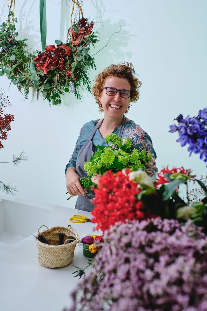 Laughing woman with bouquet of trachelium flowers