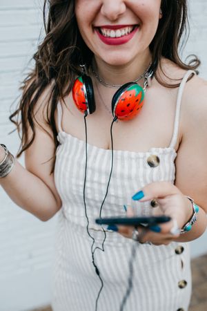 Woman with bright headphones and mobile phone