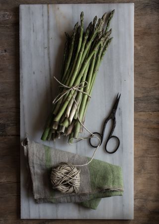 Arrangement of twine and asparagus on board