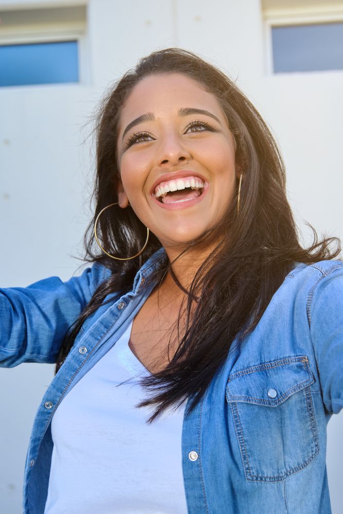 Cheerful young woman smiling and looking away