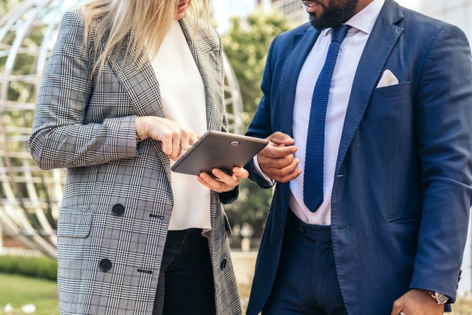 Coworkers talking about business outdoors