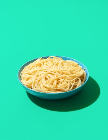 Spaghetti bowl isolated on a green background