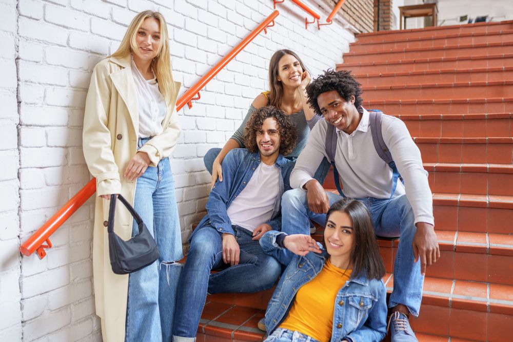 Smiling friends on brick steps