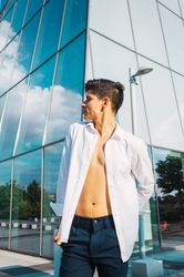 Handsome man in button up shirt against skyscraper