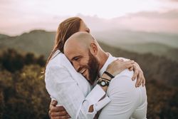 Affectionate couple having fun on hilly valley