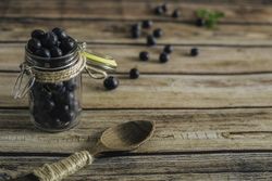 Tasty bilberry on wooden surface