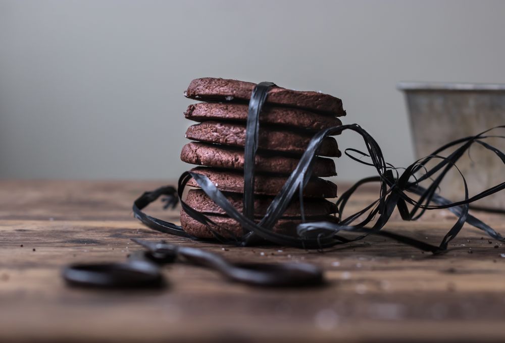 Stack of chocolate cookies tied with black ribbon