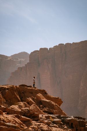 Anonymous woman standing in rocky terrain