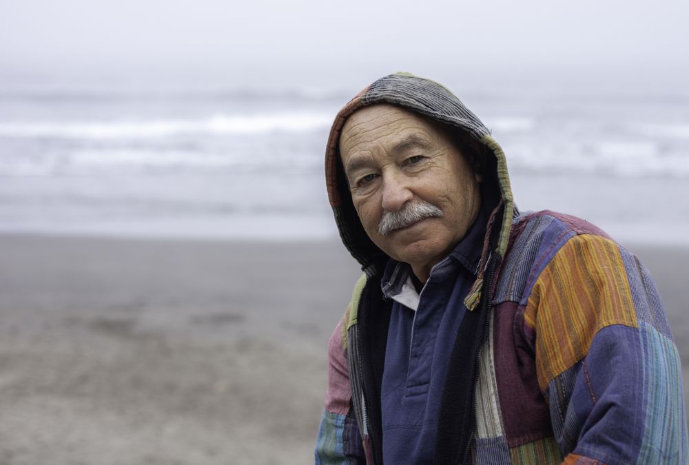Mature man on empty ocean seashore