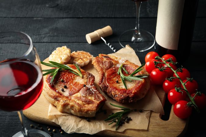 Composition with fried steaks and wine. Grilled food