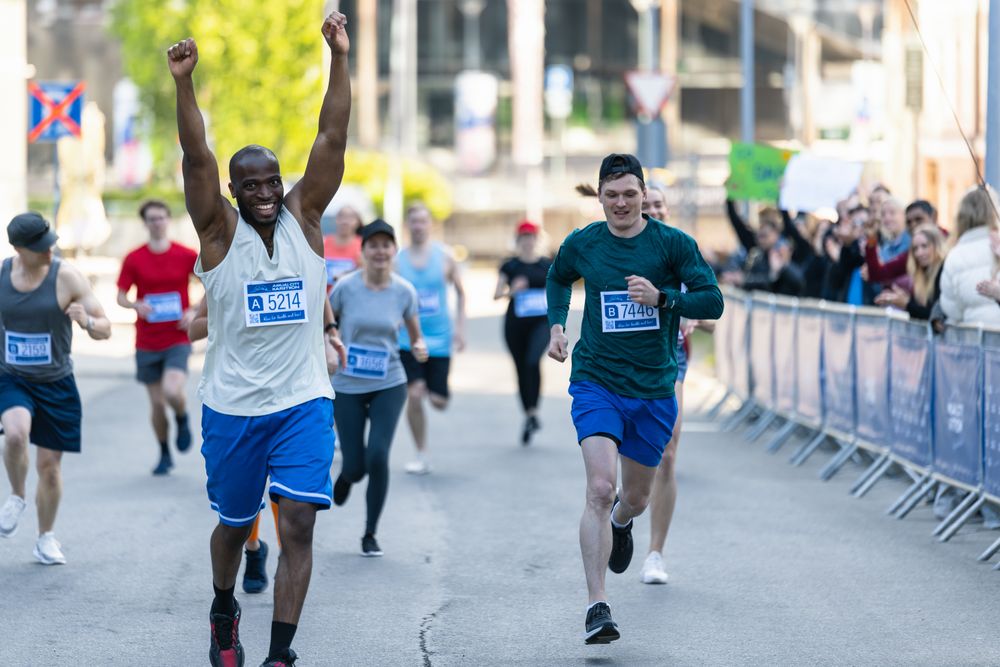 Portrait of Smiling Young Black Man Running in a City Marathon
