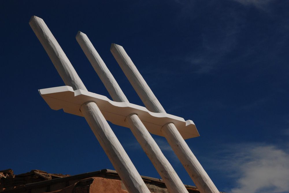 Historic ceremonial kiva ladder against blue sky