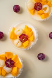 Three bowls of pudding fruit with a flower like shape from grape