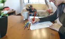 Young woman coloring mandalas