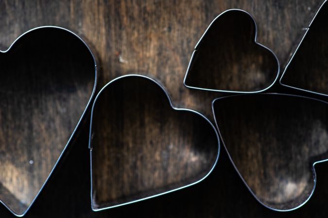 Heart shaped cookie cutters on wooden counter