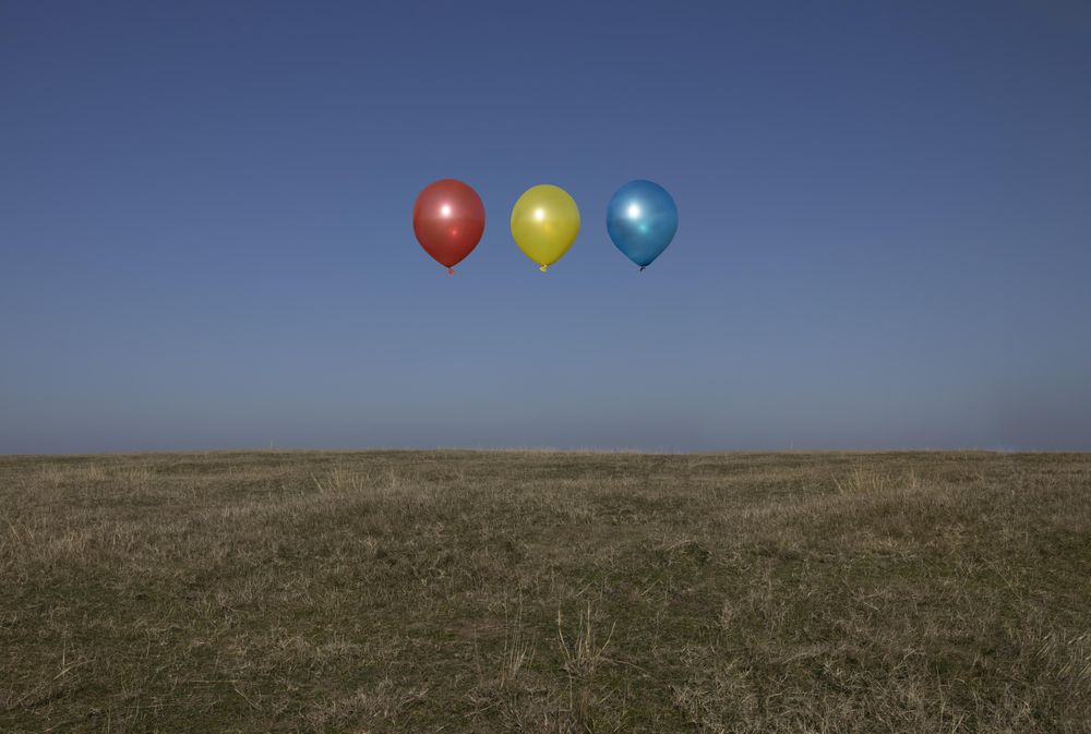Floating balloons above a field