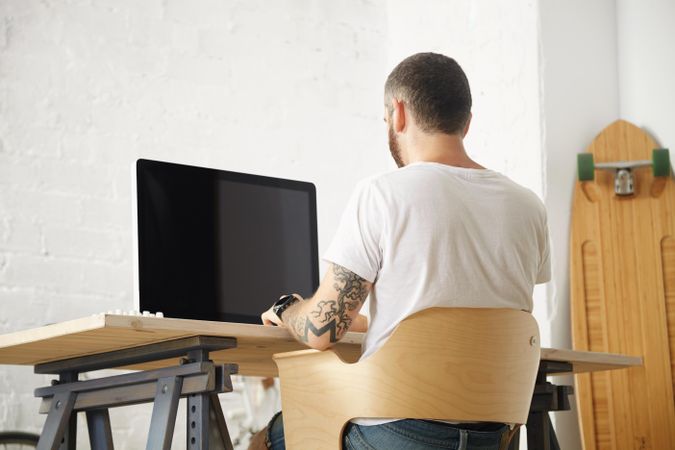 Man at computer in bright and modern home office