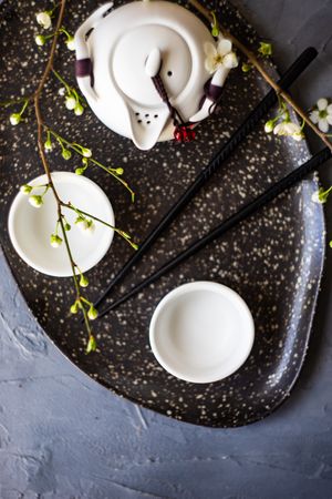 Top view of Asian style tea set with floral branches