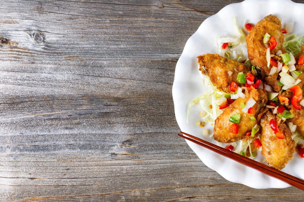 Asian style chicken wings on rustic wood