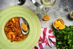 Risotto with sea food served with chill wine and lemon slices