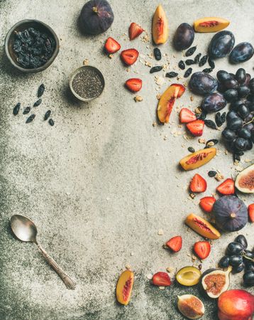 Fruit assortment with figs, grapes, peaches, strawberries, and chia seeds, copy space