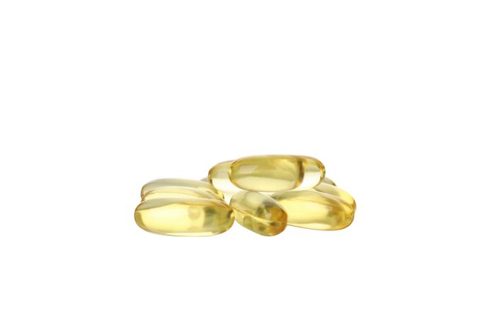 Omega pills close-up, isolated on blank background